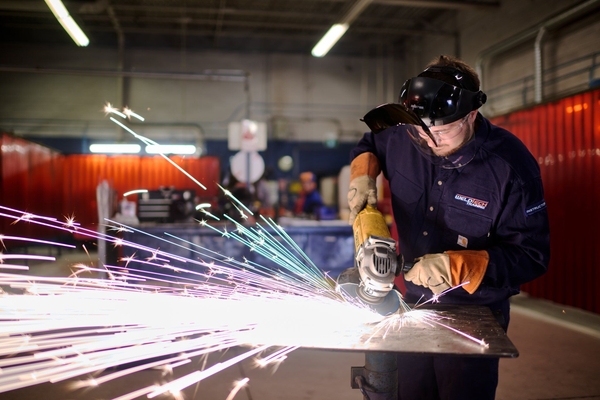 A welder recording video of their work for digital portfolio